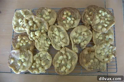 Freshly baked cookies cooling on a wire rack after being removed from the oven.