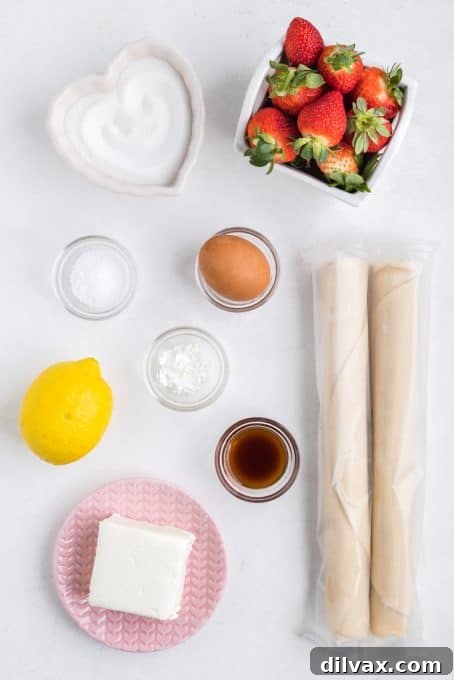Fresh ingredients laid out for Strawberry Cream Cheese Hand Pies, including strawberries, cream cheese, and lemons