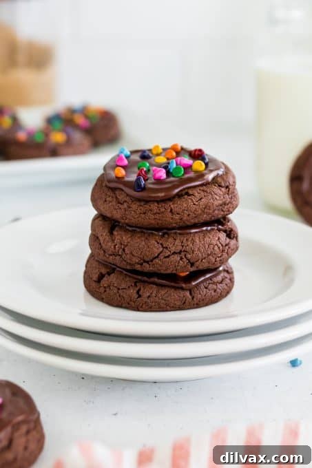 Close-up of a frosted Cosmic Brownie Cookie on a cooling rack