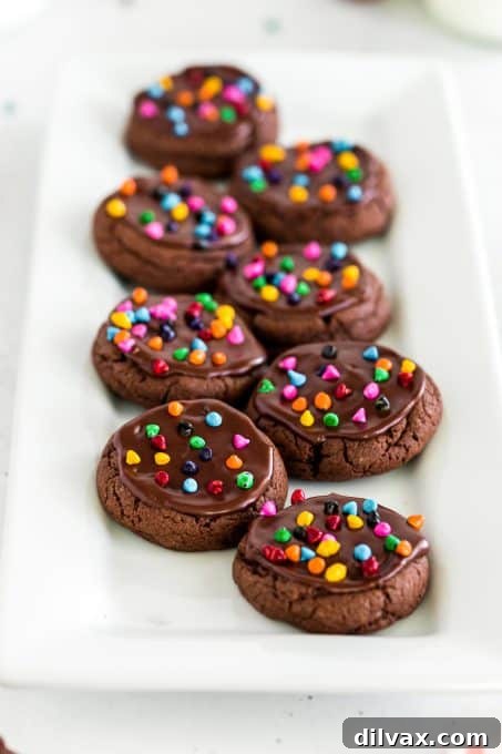 Stacked chocolate cosmic cookies with vibrant sprinkles, ready to be enjoyed