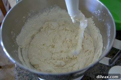 French Bread: A Baker's Journey 3 Close-up of a partially risen French bread dough on a baking sheet, showing its texture.