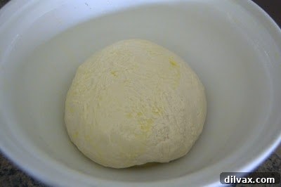 French Bread: A Baker's Journey 5 French bread loaves freshly baked, exhibiting a light golden crust and modest rise.