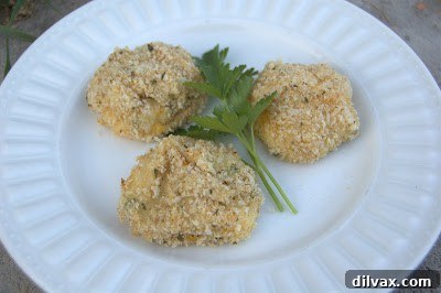 A close-up of a golden-brown, crispy baked potato bite, showing its delicious texture.