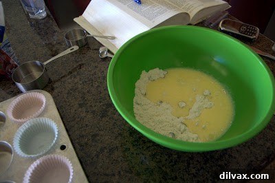 Dried cranberries being folded into muffin batter.