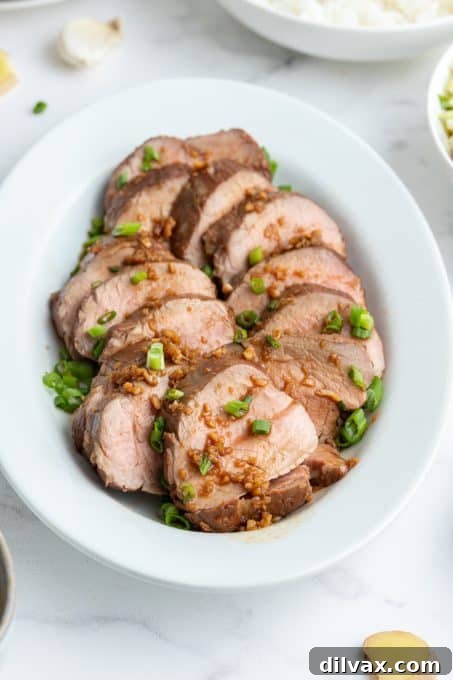 Sticky Asian Glazed Pork Tenderloin 7 Asian marinated pork, sliced and arranged beautifully on a serving platter