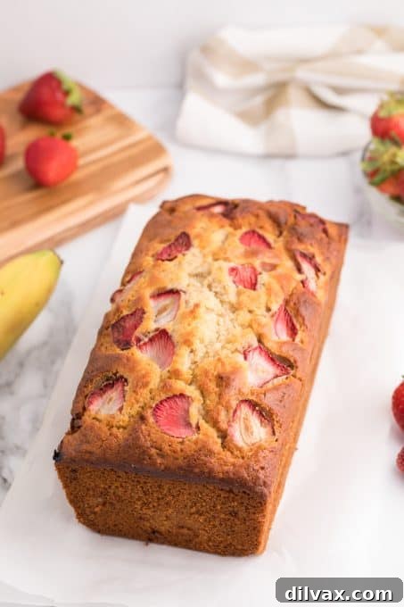 A slice of quick bread featuring strawberries and bananas