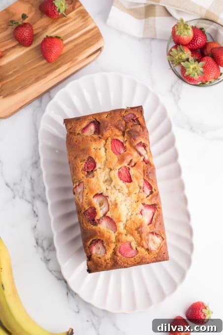 A slice of banana and strawberry bread with visible fruit pieces