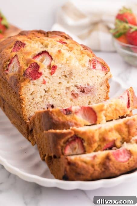 Full loaf of Strawberry Banana Bread on a cooling rack