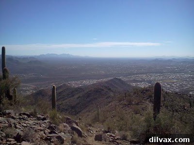 Close-up of rock formations on a mountain top with sky in background
