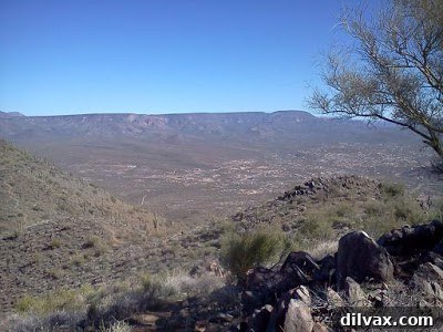 Wide shot of mountain ridge and valley below