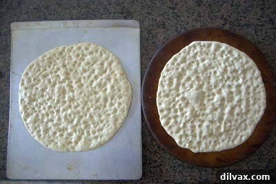 Close-up of dimpled flatbread dough, ready for toppings