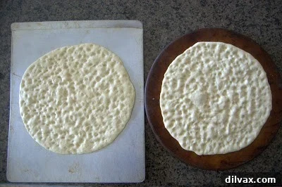 Dimpling the dough with fingertips