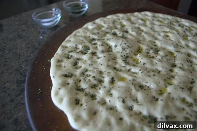 Rosemary and salt sprinkled on flatbread, ready for baking