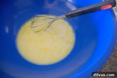 Mixing wet ingredients and activated yeast in a bowl