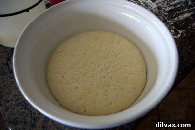Shaping flatbread dough into circles on baking sheets
