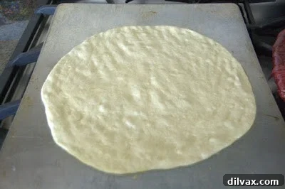 Dough shaped into circles on oiled baking sheets