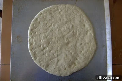 Shaped dough circles rising on baking sheets