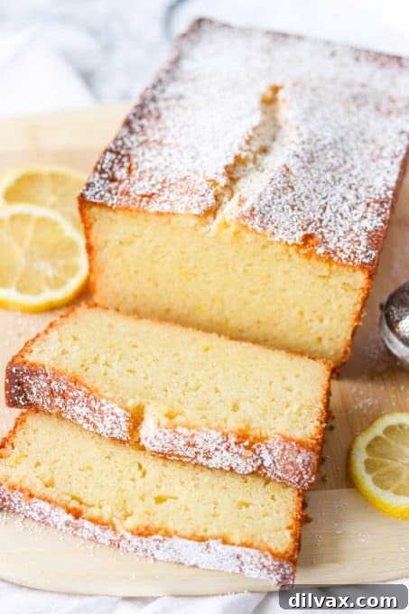 A beautifully golden-brown Lemon Ricotta Pound Cake on a rustic wooden board, ready to be sliced.