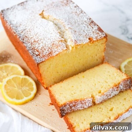 Sliced Lemon Ricotta Pound Cake on a cutting board, garnished with lemon slices.