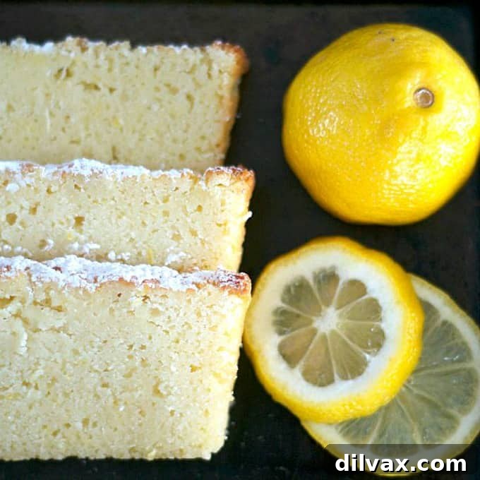 A beautifully baked Lemon Ricotta Pound Cake, golden brown and garnished with fresh lemon slices, ready to be enjoyed.