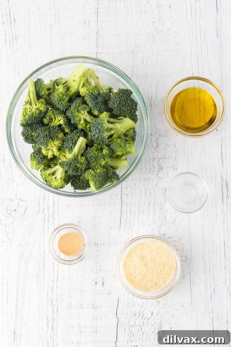 Essential ingredients for Roasted Parmesan Broccoli: fresh broccoli, olive oil, garlic powder, salt, and Parmesan cheese