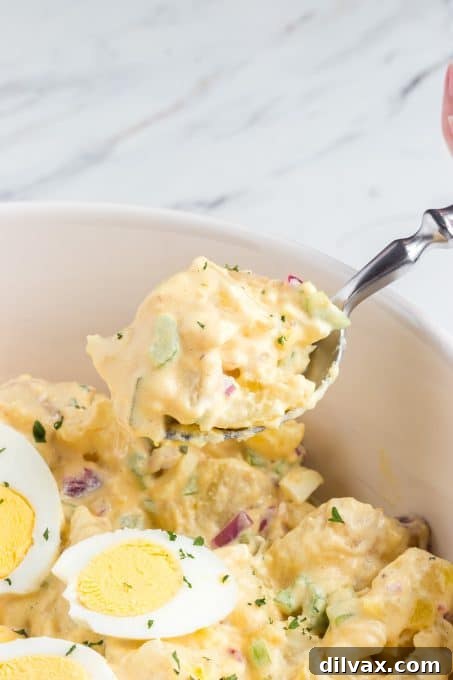 A spoonful of homemade potato salad with Chick-fil-A sauce