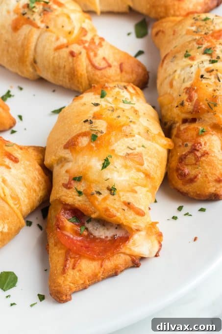 Effortless Pepperoni Crescent Rolls 9 A generous serving of Pepperoni Pizza Crescents on a plate, ready to be enjoyed as a snack or appetizer.