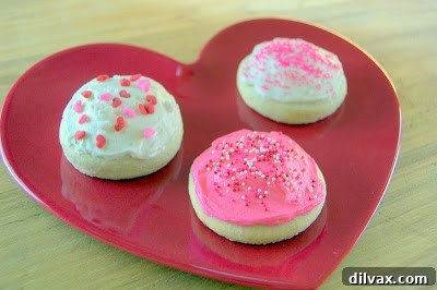 A batch of Frosted Sugar Cookies (Lofthouse-style) fresh out of the oven, waiting to be frosted.