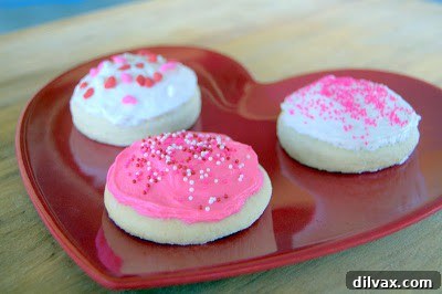 Close-up of a beautifully frosted Lofthouse-style sugar cookie with sprinkles.