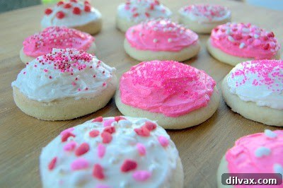 A basket full of delicious, homemade frosted sugar cookies.