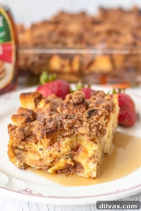 Overnight Cinnamon French Toast Bake 3 A perfectly sliced piece of Baked Cinnamon French Toast, showing its soft interior and crispy topping.