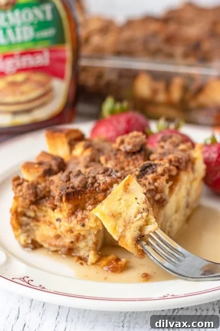 Overnight Cinnamon French Toast Bake 9 A close-up of a bite taken from an overnight French Toast slice, showcasing its soft texture.