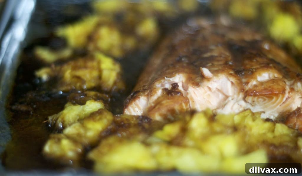 Golden Glazed Salmon with Pineapple Caramel 2 Salmon marinated in a brown sugar honey sauce and baked along side some fresh pineapple.
