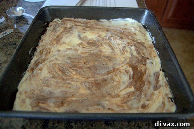 Freshly baked cream cheese brownies cooling in the pan after coming out of the oven.