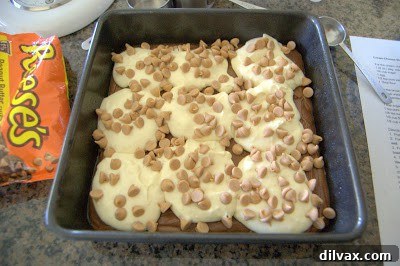 Placing small spoonfuls of the remaining brownie batter on top of the cream cheese mixture.