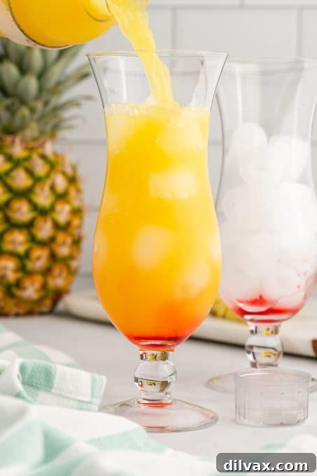 Tropical Empress 5 The final pour of a tropical cocktail over grenadine.