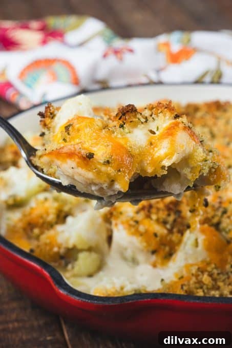 Golden Baked Cheesy Cauliflower 3 Close-up of a serving of homemade Cauliflower Gratin in a baking dish.