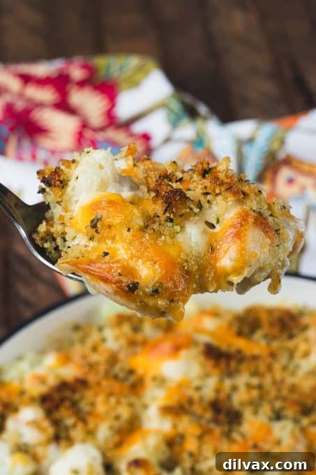 Golden Baked Cheesy Cauliflower 9 A close-up view of a serving of cheesy cauliflower gratin, showcasing its golden crust and creamy interior.