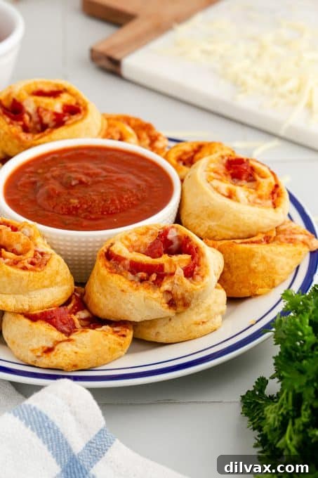 Cheesy Pepperoni Pizza Spirals 9 Ingredients for pepperoni pizza pinwheels including cheese, pepperoni, sauce, and crescent dough.