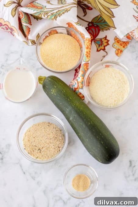 Golden Cornmeal Zucchini Crisps 4 All the fresh and dry ingredients meticulously laid out on a kitchen counter, ready for making delicious Air Fryer and Baked Zucchini Chips.