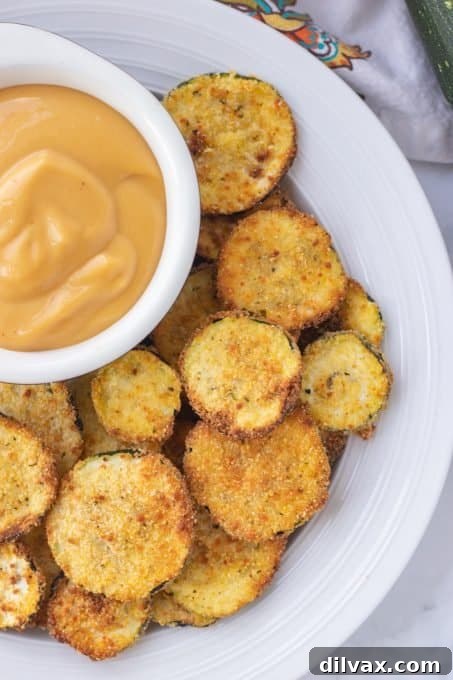Golden Cornmeal Zucchini Crisps 7 A close-up shot of golden cornmeal breaded zucchini chips, freshly cooked in the air fryer, perfectly crisp and ready to be enjoyed.