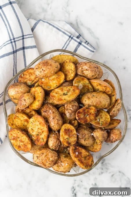 Perfectly Crispy Air Fryer Potato Bites 4 Air fried baby potatoes on a serving dish, steam rising