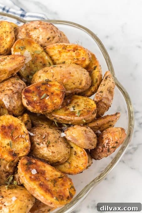 Perfectly Crispy Air Fryer Potato Bites 9 Air fryer baby potatoes served on a plate with fresh herbs