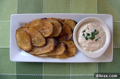 Crispy baked taco chips arranged on a plate with the dipping sauce in a small bowl