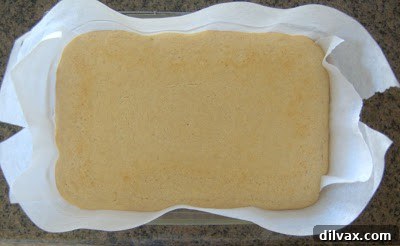 Delightful Eggless Vanilla Cardamom Cake 9 Baked cake cooling in the baking dish on a wire rack