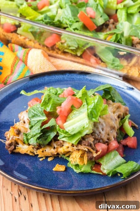 A hearty casserole featuring Fritos, savory taco meat, and fresh toppings