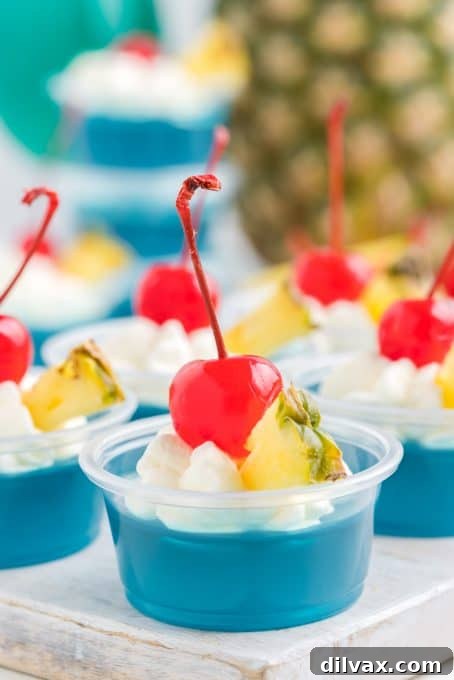 Easy Blue Hawaiian Jello Shots: Bring the Tropics Home 7 Easy tropical jello shots showcasing the beautiful blue color, made with blue gelatin, coconut rum, and pineapple juice.