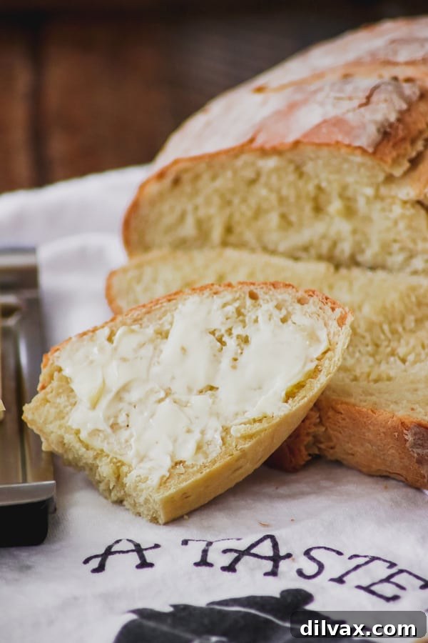 Artisan Italian Loaves 12 A buttered slice of Grandma's Italian Bread, ready to eat.
