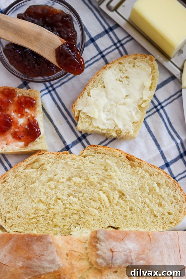 Artisan Italian Loaves 14 Jam, butter, and a fresh slice of Grandma's Italian Bread on a napkin, for breakfast.