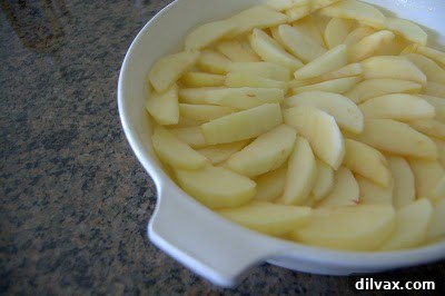 Peeled and sliced apples in a baking dish
